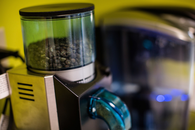 Close up of a coffee grinding machine